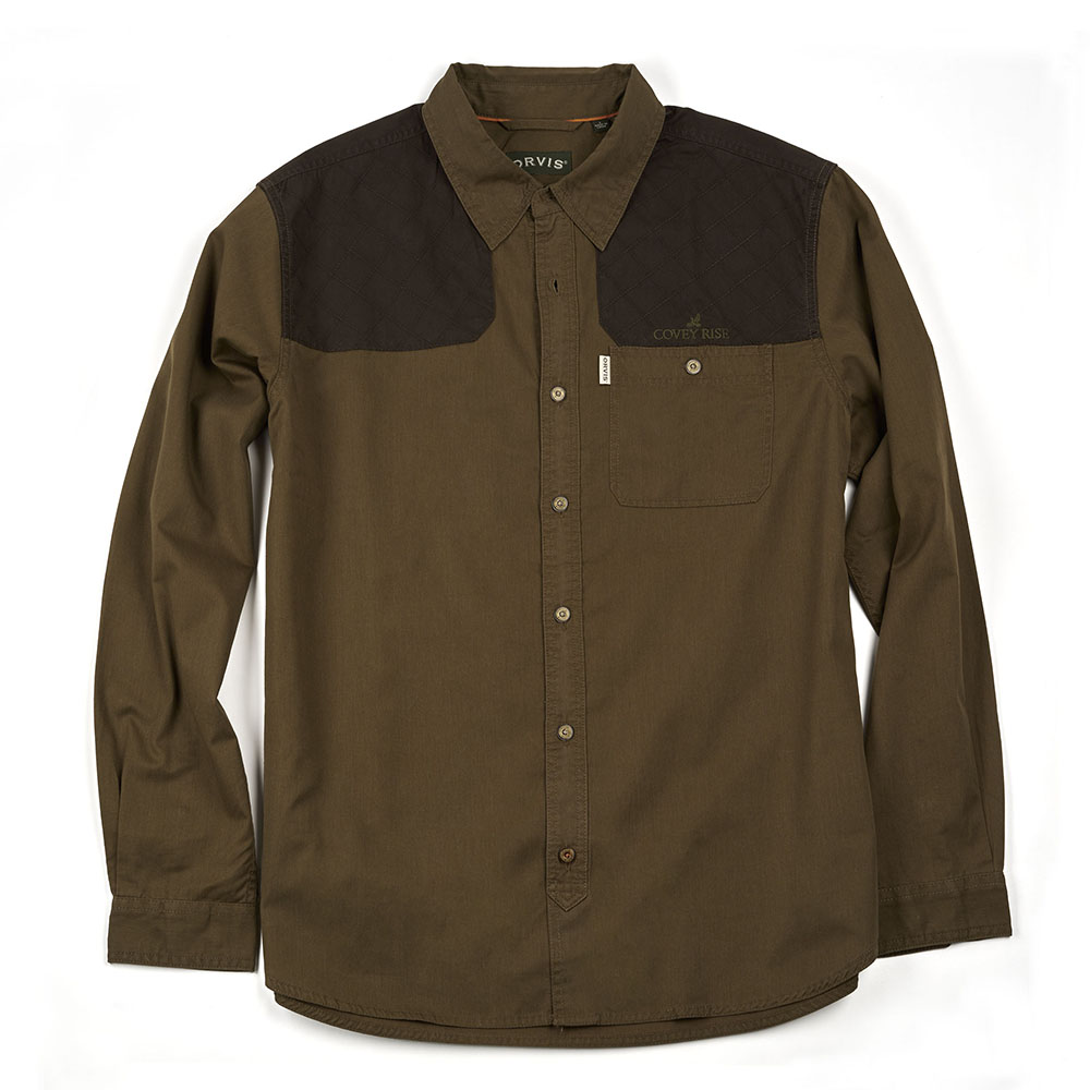 A good hunting shirt must be comfortable and rugged, a challenging combination. This Orvis shooting shirt meets the challenge. It has the soft, easy feel of cotton plus performance qualities needed to withstand the wear and tear of days in the field. The fabric is an advanced blend of cotton, reinforced with polyester. Ambidextrous design with quilted shooting patches. Hidden button-down collar, button-through patch chest pocket, and pleated upper yoke panel for mobility. Cotton/polyester. Washable. Imported. Covey Rise embroidered logo on left chest. Also available in tan/blaze.